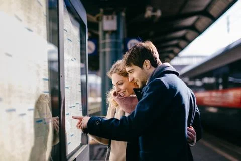Couple checking schedule at train station, Firenze, Toscana, Italy Stock Photos