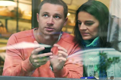 Couple checking something on cellphone in the cafe Stock Footage 43147221