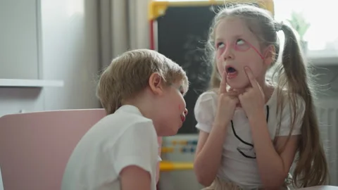 Couple of cheerful children laughs and Stock Video Pond5