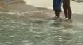 A couple of children standing on water at the beach HD Footage