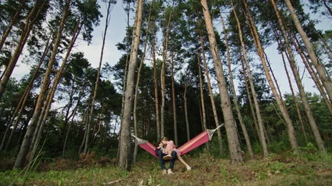 Couple chilling on hammock amidst trees Vídeos de archivo 219953692