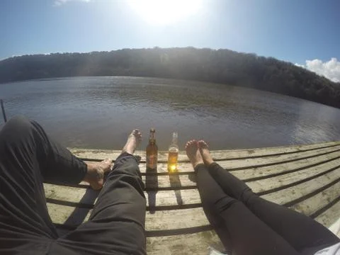 Couple chilling next to the river Stock Photos