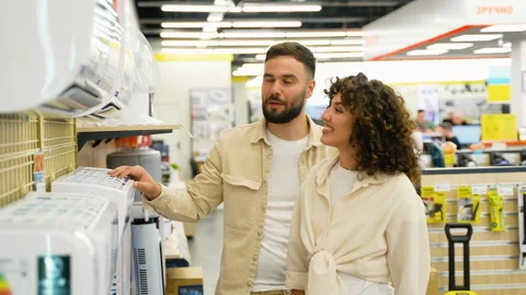 Couple choosing air conditioner in electronics store on Black Friday Stock Footage 317729835