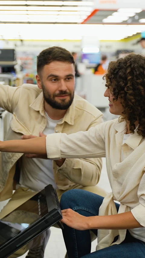 Couple choosing new oven in electronics store on Black Friday Stock Footage 317734845