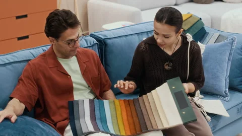 Couple Choosing Textile Sample from New Collection in Furniture Showroom Stock Footage 313936542