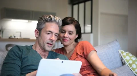 Couple choosing tv program on digital tablet Video stock 61478701