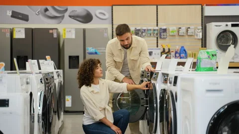 Couple choosing washing machine in electronics store on Black Friday Stock Footage 317728336