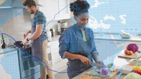 Couple chopping and stirring, making meal in kitchen, blue tech charts appearing Stock Footage 333154115