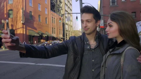 Couple in city pose for selfies Stock Footage 62465491