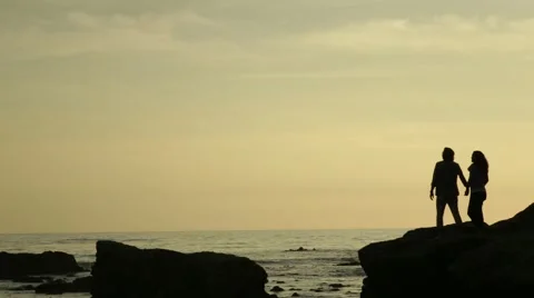 Couple on a cliff at sunset Video stock 40042195