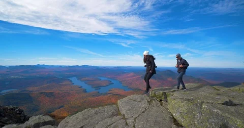 Couple Climbing on Edge of Cliff &amp; Mountain Together, Adventurous Stock Footage 102401493