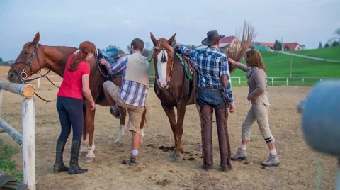 Couple climbing on the horses Stock Footage 45544650