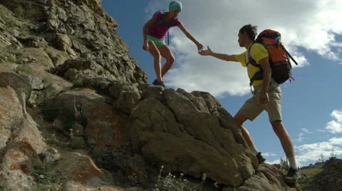 Couple climbing mountain range Stock Footage 68581255