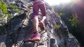 A couple climbing a mountain vertical Stock Footage 85837943