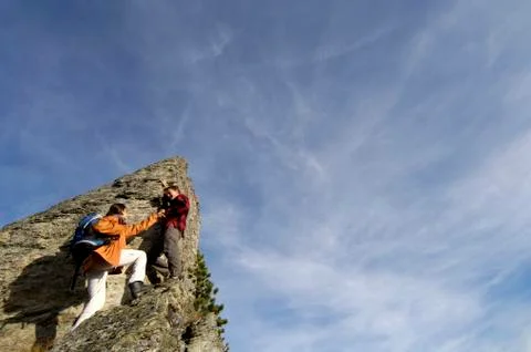 Couple climbing on summit Stock Photos