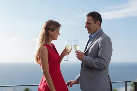 Couple clinking their flutes of champagne Stock Photos