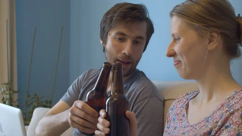 Couple clinks beer bottles Stock Footage 129233455