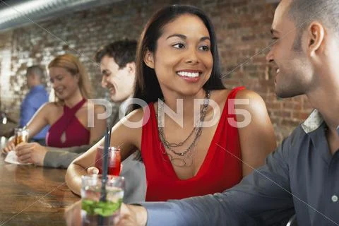 Couple With Cocktails At Bar Stock Photos