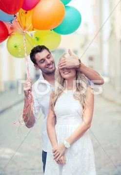 Couple with colorful balloons Stock Photos