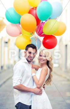 Couple with colorful balloons Stock Photos