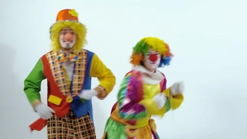 A couple of colorful clowns are dancing a funny dance showing holiday emotions Stock-Footage 70284953