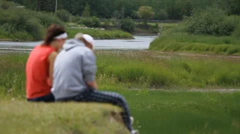 Couple in conversation in park Stock Footage 10757280