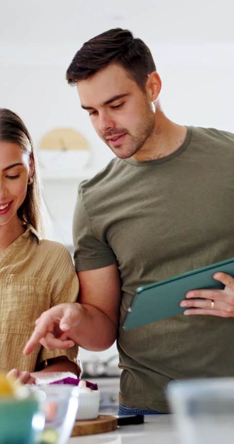 Couple, cooking and talk with tablet in kitchen, online or learning culinary Stock Footage 337151645