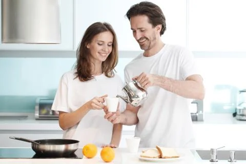 Couple cooking breakfast Stock Photos