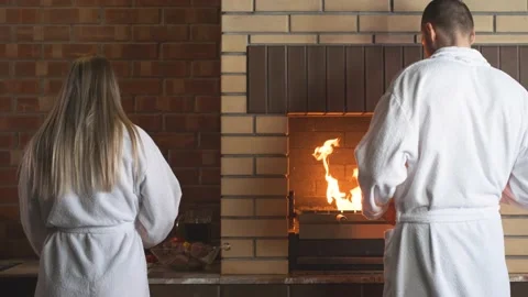 The couple is cooking dinner. Fireplace. Stock Footage 151099546