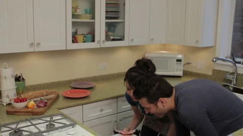 Couple cooking together in the kitchen Stock Footage 1047061