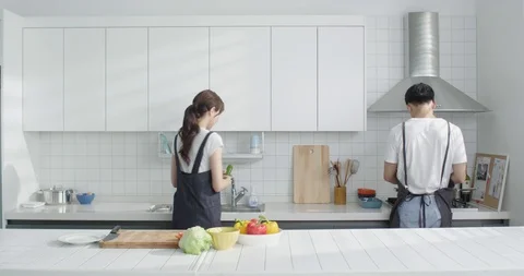 Couple cooking together in the kitchen Stock Footage 100947667