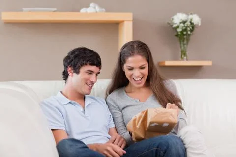 Couple on the couch with parcel Stock Photos