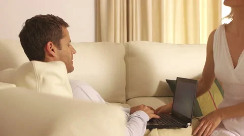 Couple on couch together with computer. Stock Footage 43660049