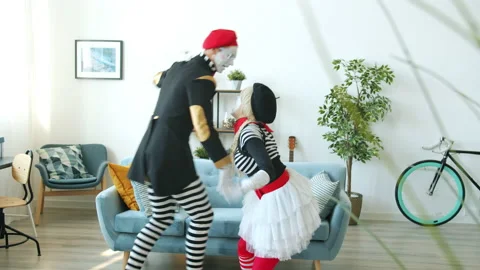 Couple of crazy mimes having fun dancing enjoying music indoors at home Stock Footage 144387504