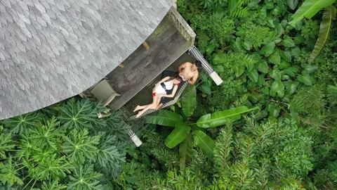 Couple Cuddle and Relax in Hammock in Bali Luxury Bamboo Villa Holiday Stock Footage 197059024