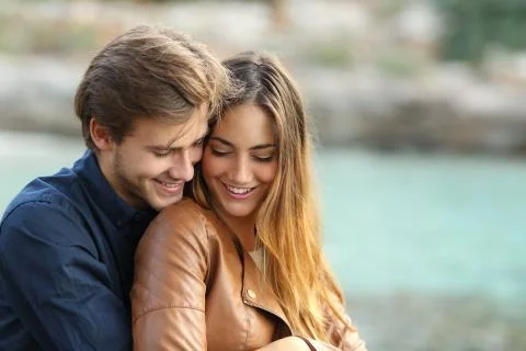 Couple cuddling affectionate on the beach Stock Photos
