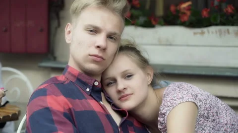 Couple cuddling and looking to the camera in the cafe Video stock 53945356