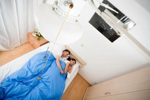 Couple Cuddling In Bed 스톡 사진