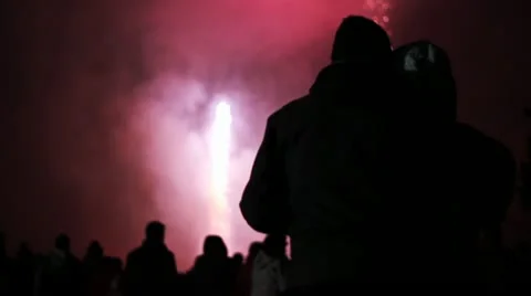 Couple Cuddling Infront of Firework Display - Silhouette Colorful Exploding Sky Stock Footage 12455627