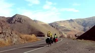 A Couple Of Cycling Travelers Moving Along The Highway In The Mountain Area Stock Footage