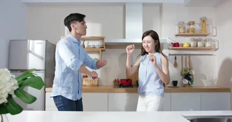 Couple dance in kitchen happily Stock Footage 137019747