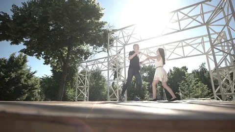 Couple dance on a stage in the park Stock Footage 77929506