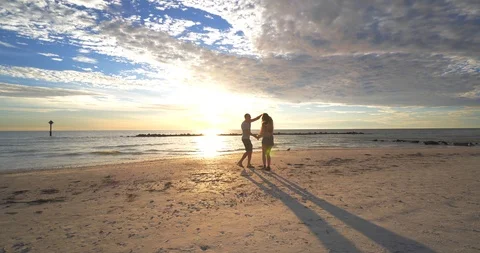 Couple Dances on Beach at Sunset, Man and Woman, Romantic Dancing Stock Footage 105827476