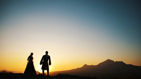 Couple dancing on a background of mountains at sunset Caucasian dance. Stock Footage 129973991