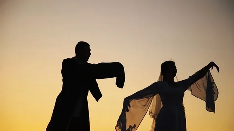 Couple dancing on a background of mountains at sunset Caucasian dance. Stock Footage 129973998