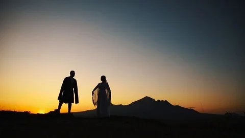 Couple dancing on a background of mountains at sunset Caucasian dance. Stock Footage 129974000