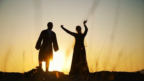 Couple dancing on a background of mountains at sunset Caucasian dance. Stock Footage 129974004
