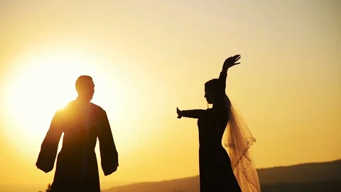 Couple dancing on a background of mountains at sunset Caucasian dance. Stock Footage 129974009