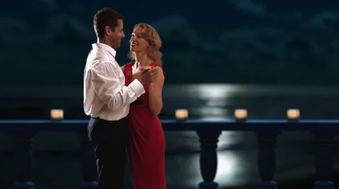 Couple dancing on a balcony at night. Stock Footage 43680867