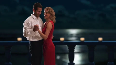 Couple dancing on a balcony at night. Stock Footage 43680878